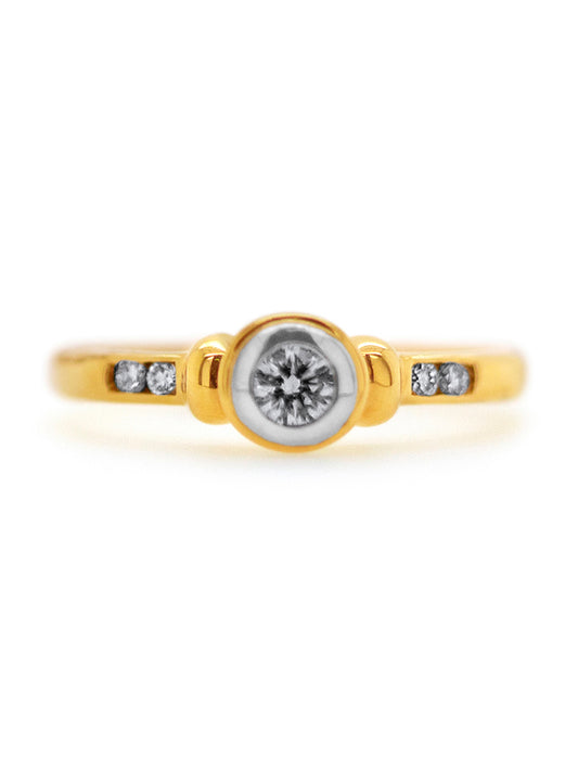 18 Carat Yellow Gold Bezel and Channel set Solitaire Diamond Ring.